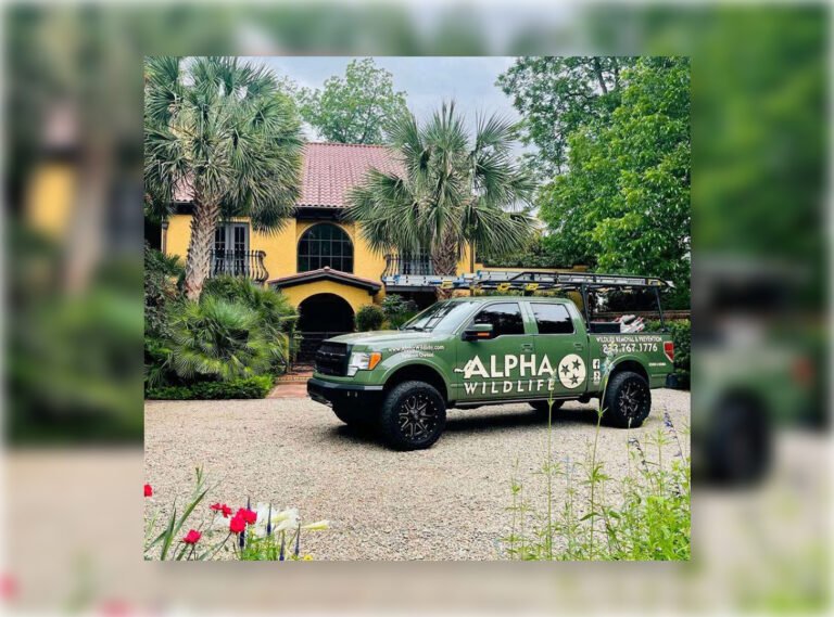 Green truck with Alpha Wildlife logo.