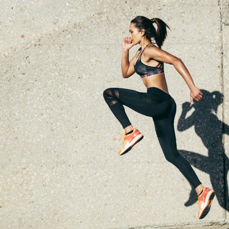 Woman in sportswear jumping in mid-air.